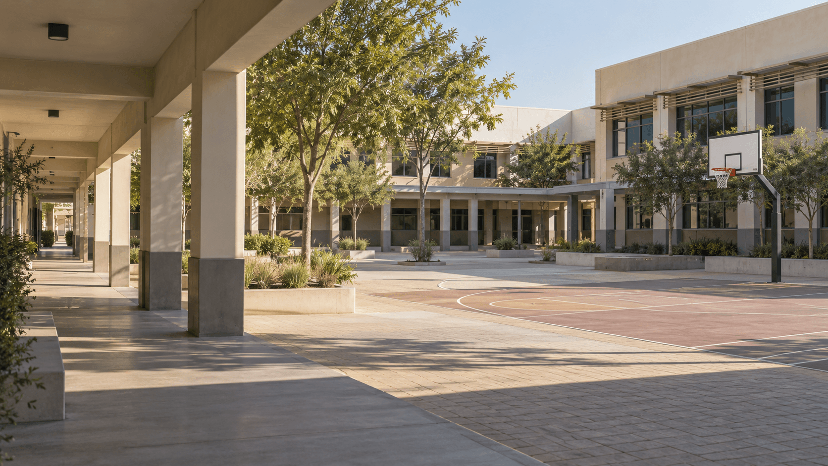 Illustrative empty school courtyard with shaded classrooms and a basketball court in a Dubai-style campus